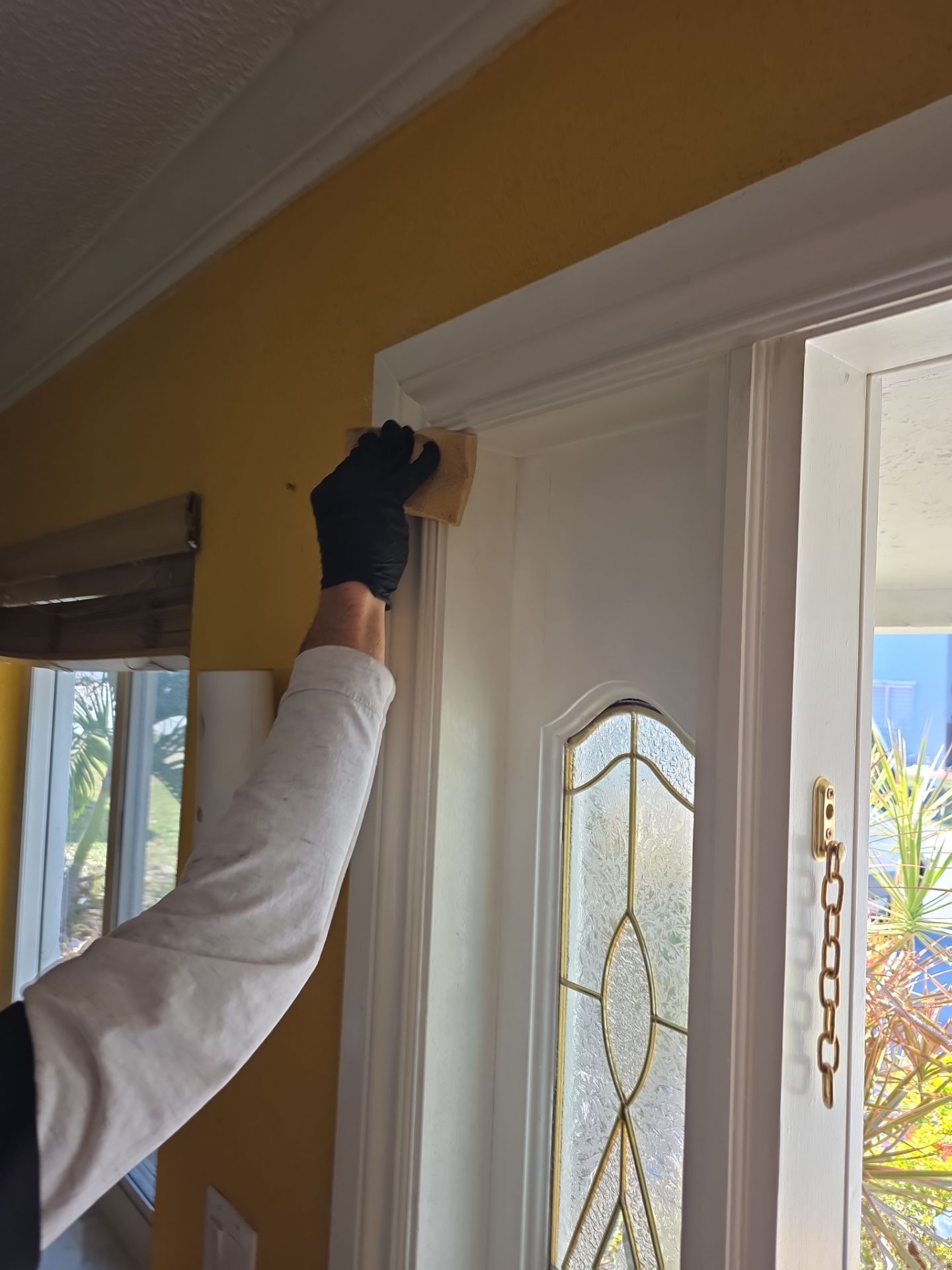 Technician cleaning smoke residue from door trim and molding